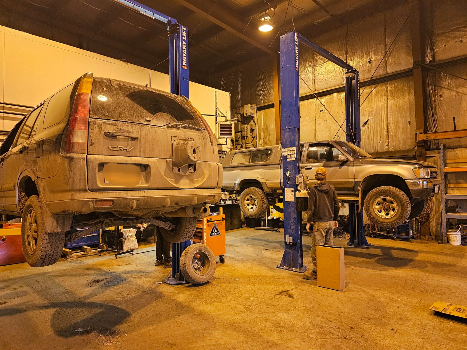 Vehicles in Red's Recovery mechanical shop on service hoists